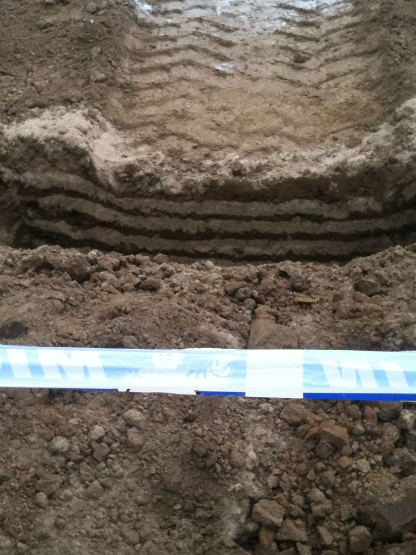 Compacted soil in layers under a tire track
